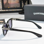 Sunglasses with gray lenses, black square frame, and silver ornate temple details.