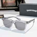 Sunglasses with gray lenses, clear frame, and silver ornate temple hardware.