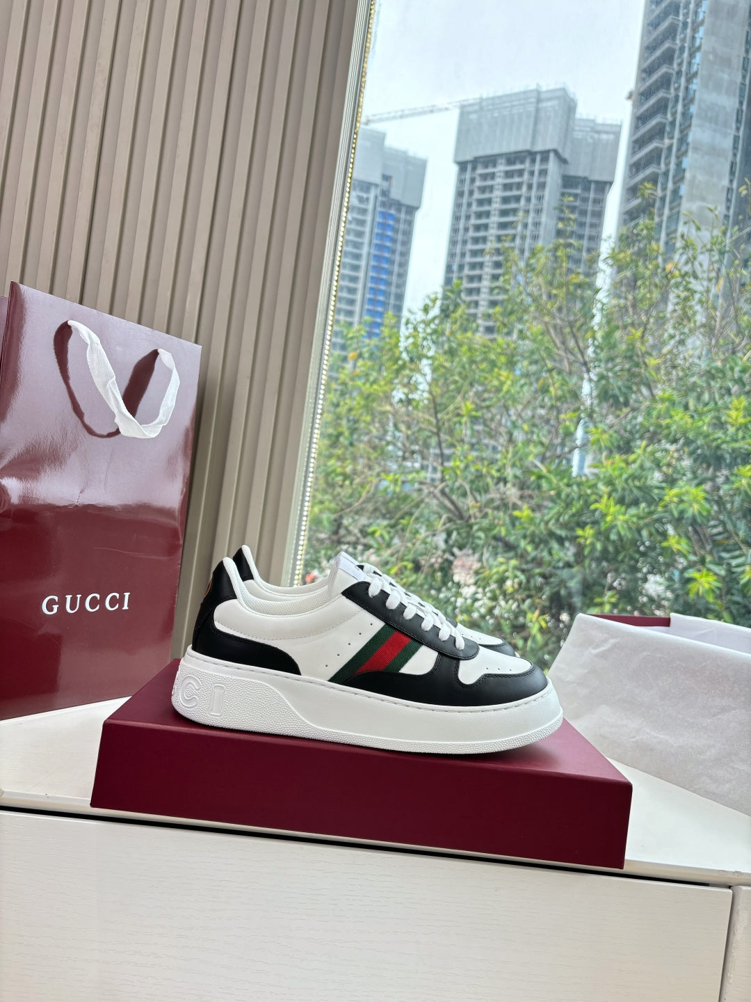 Gucci low-top sneakers, white-and-black with multicolor stripe across the side