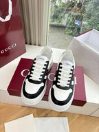 Gucci low-top sneakers, white uppers with black side panels, lace-up front