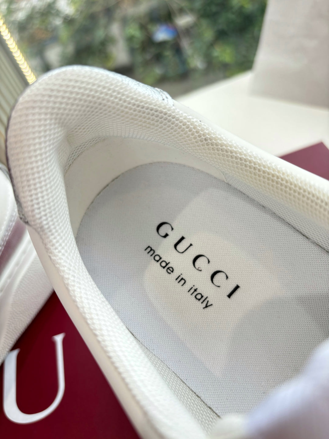 Gucci sneaker insole text reading “GUCCI” and “made in Italy” on light interior