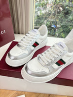 White Gucci leather sneakers pair with red and green side stripe, lace-up front