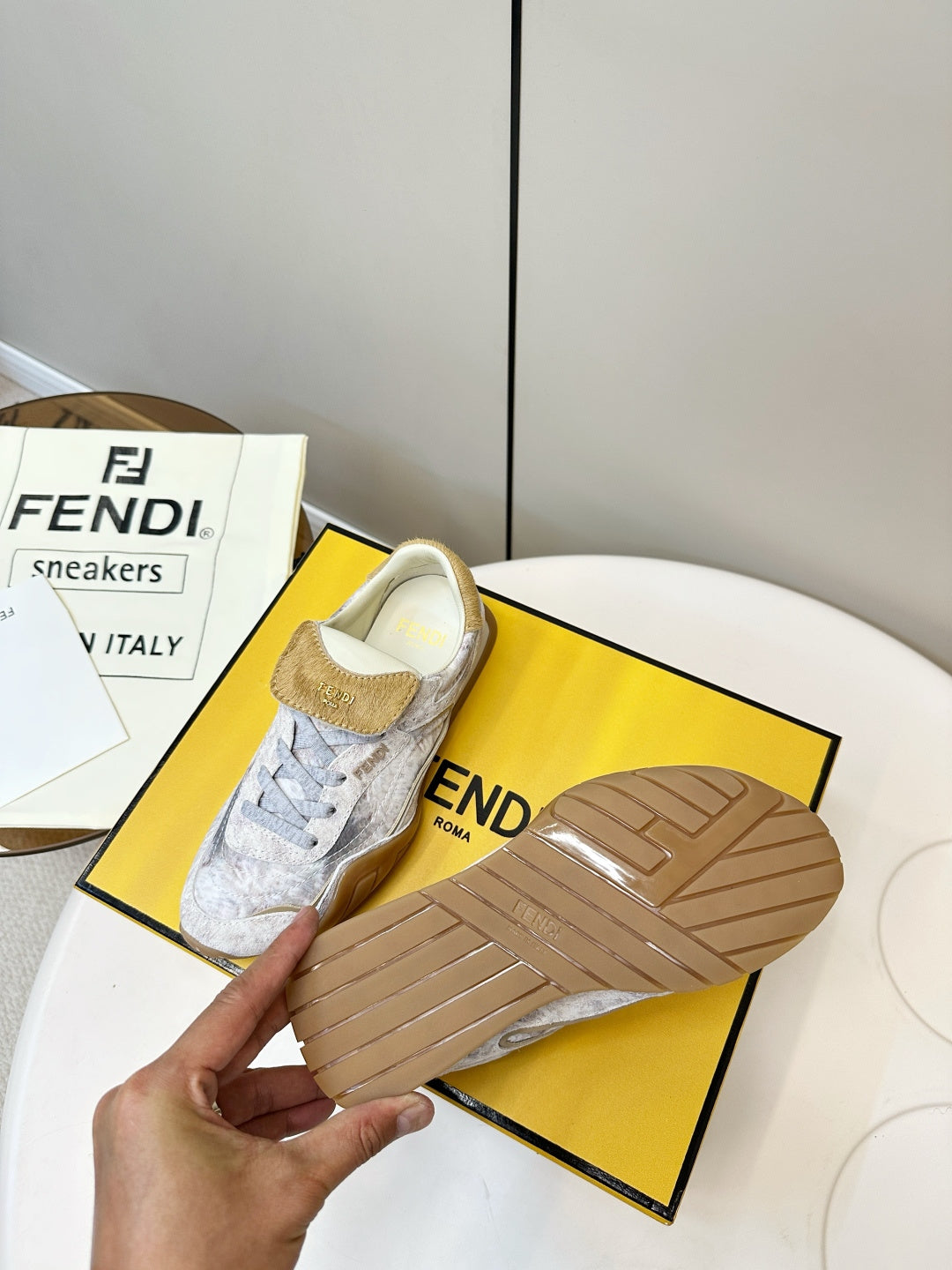 Fendi unisex sneakers with light gray uppers and tan textured sole