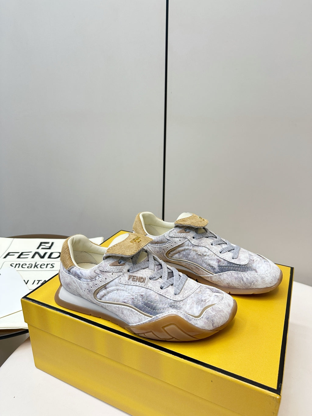 Fendi unisex sneakers, light gray uppers with tan suede accents and lace-up design.