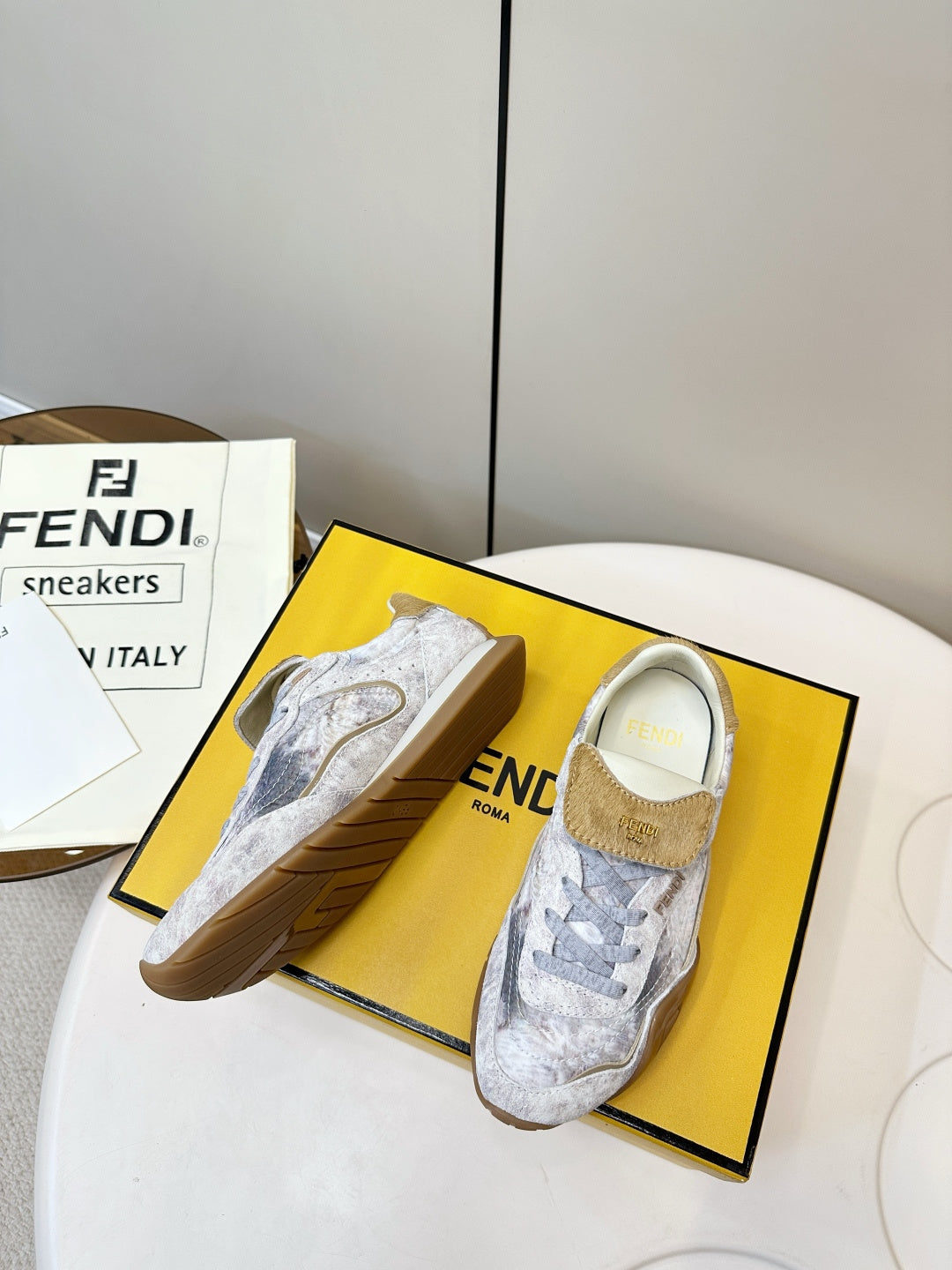 Fendi unisex sneakers, light gray textured fabric with tan suede heel accents.