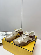 Fendi unisex low-top sneakers on a box, metallic gold leather with brown accents and laces