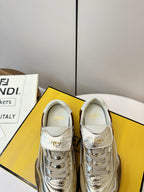 Fendi unisex sneakers front view, metallic gold uppers with brown heel tab and white laces