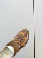 Fendi unisex sneaker close-up, brown patterned upper with lace-up front and white trim
