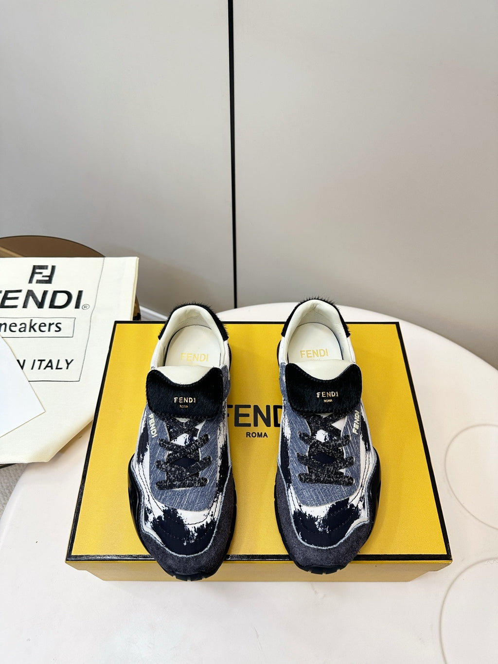 Fendi unisex sneakers in navy and white with black heel and front FENDI logos