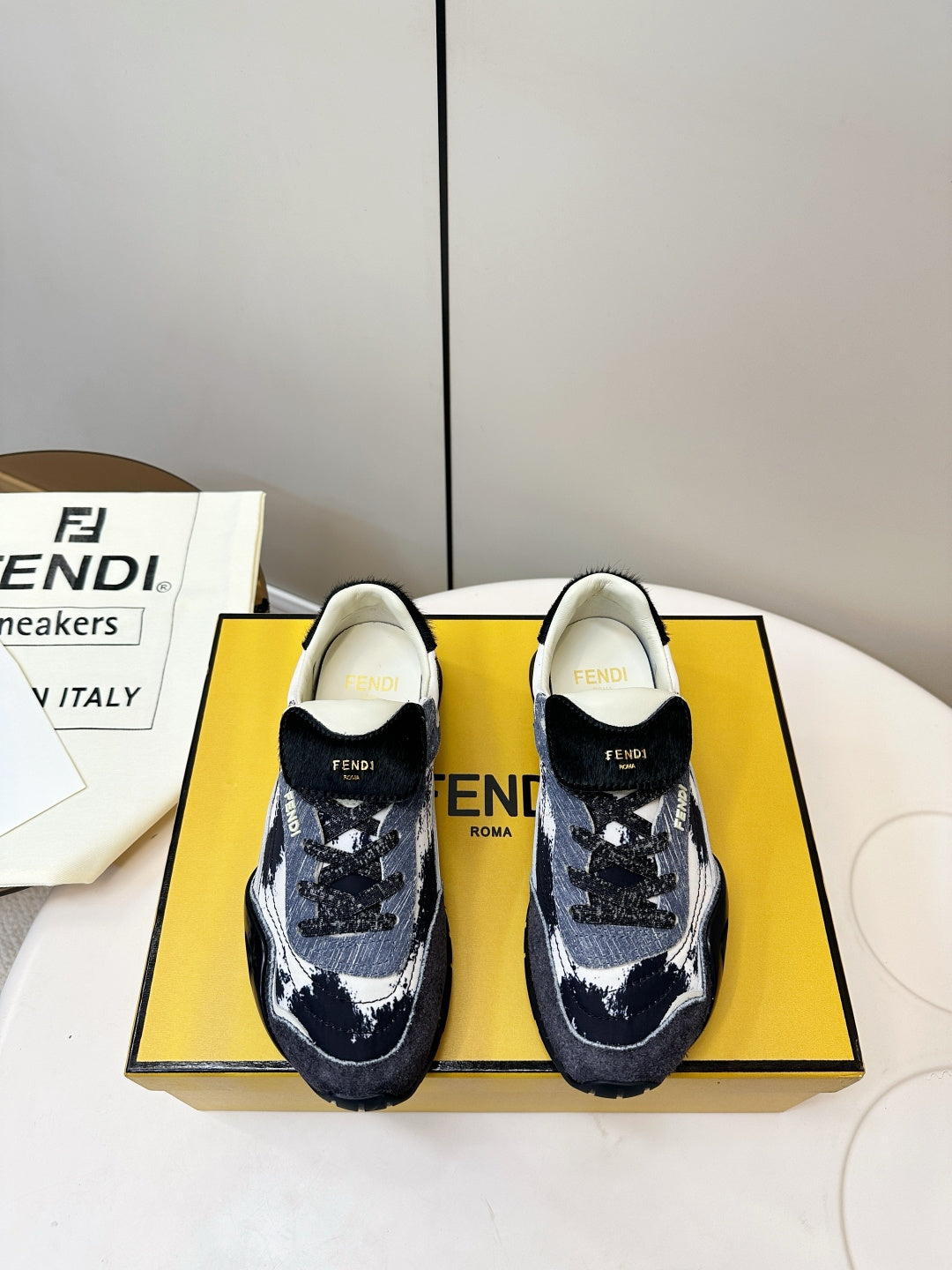 Fendi unisex sneakers in navy and white with black heel and front FENDI logos