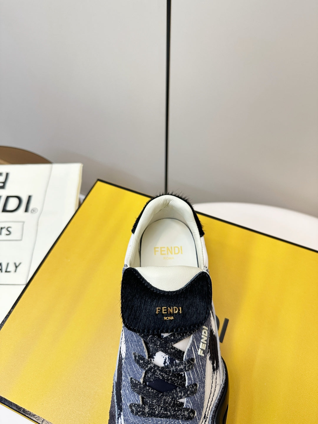 Fendi unisex sneaker with inner collar showing FENDI branding and navy upper