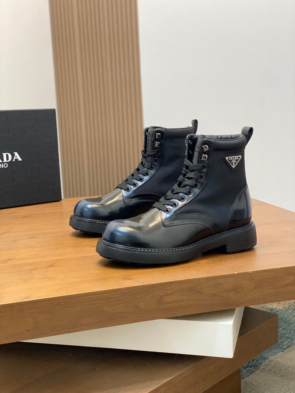 Prada ankle boots, lace-up styling, glossy dark blue finish, low-profile tread sole