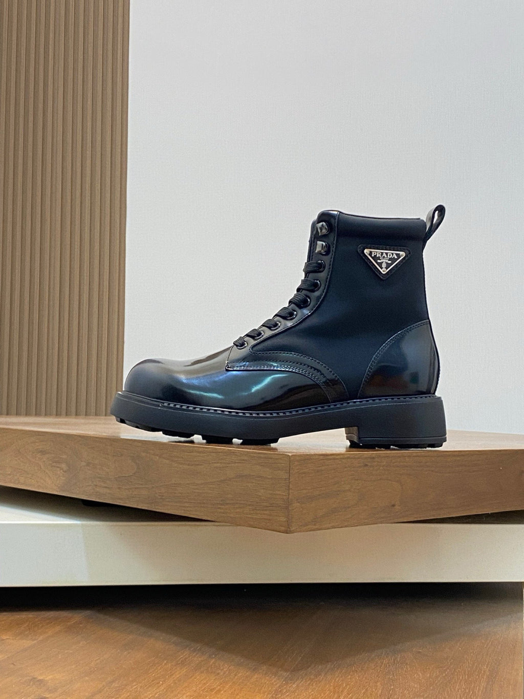 Prada lace-up ankle boots with side logo patch, glossy dark blue upper, rugged sole