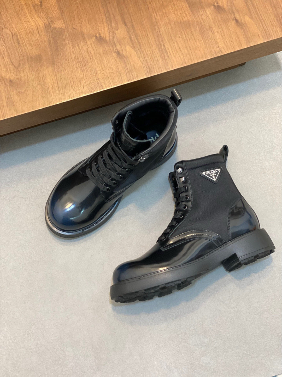 Prada lace-up ankle boots, glossy dark blue upper, front laces and chunky rubber sole