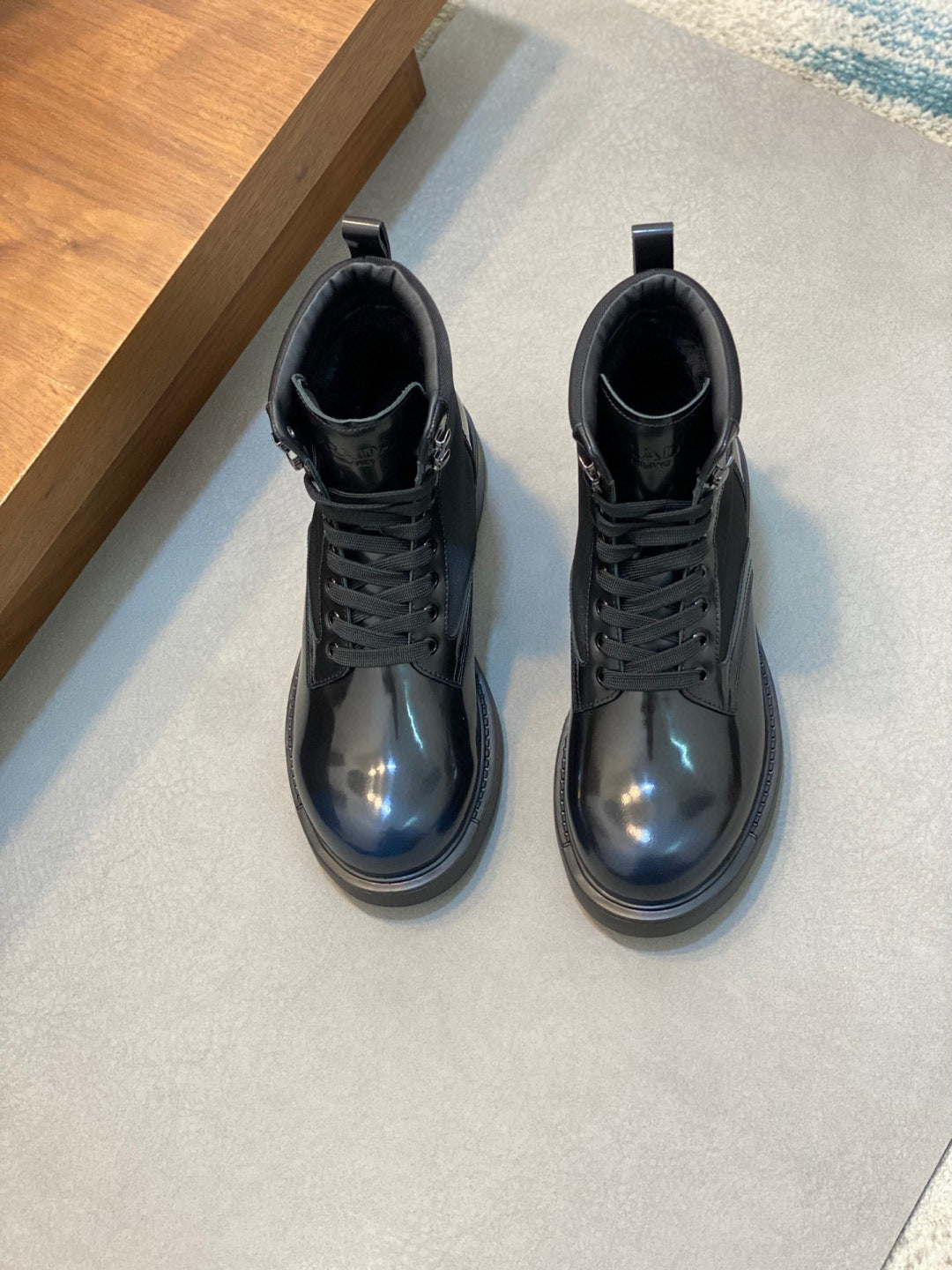 Prada lace-up boots, glossy dark blue leather, rounded toe, thick rubber sole