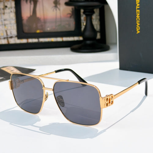 Gold-framed sunglasses with dark blue lenses and black-accent temples