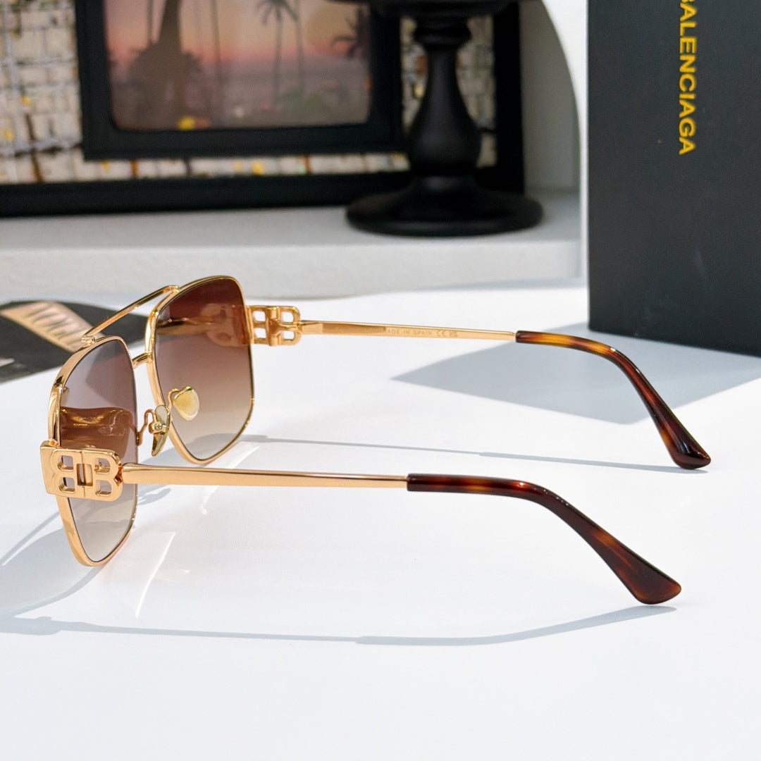 Gold-framed sunglasses with brown gradient lenses, side profile