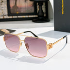 Gold-framed sunglasses with pink-purple tinted lenses and metal bridge detail
