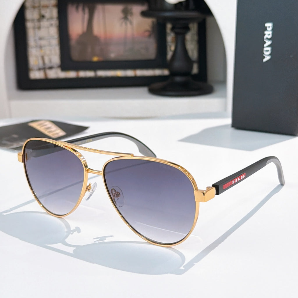 Prada sunglasses with gold frame and purple gradient lenses