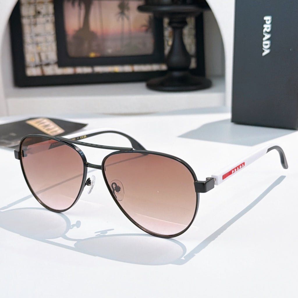 Prada sunglasses with black frame and rose gradient lenses
