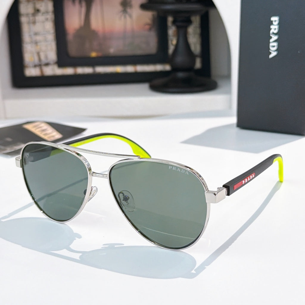 Prada sunglasses with silver frame and green gradient lenses