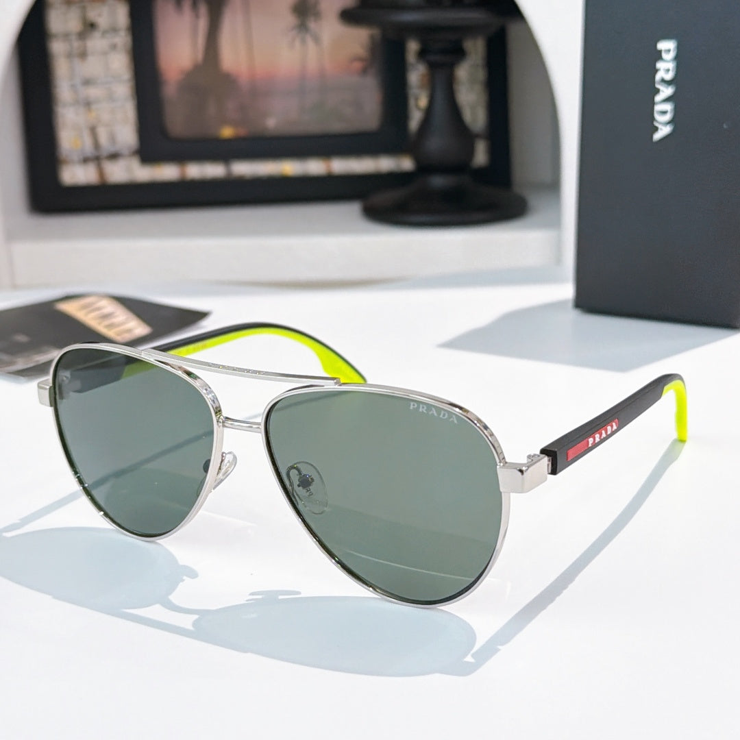 Prada sunglasses with silver frame and green gradient lenses