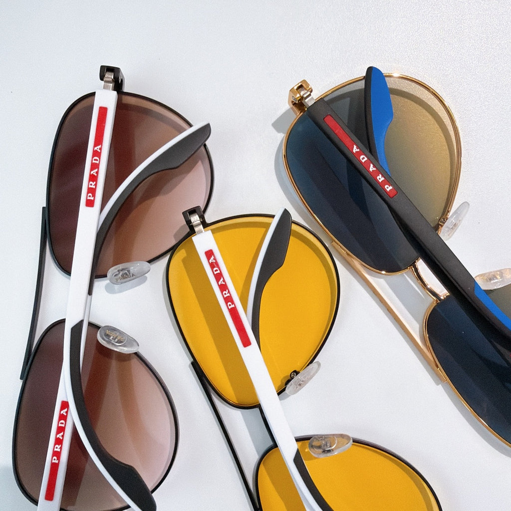 Prada sunglasses set with yellow and dark gradient lenses, black and gold frames