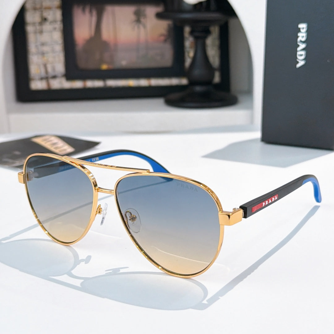 Prada sunglasses with gold frame and light blue gradient lenses