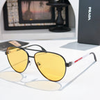 Prada sunglasses with gold frame and yellow gradient lenses
