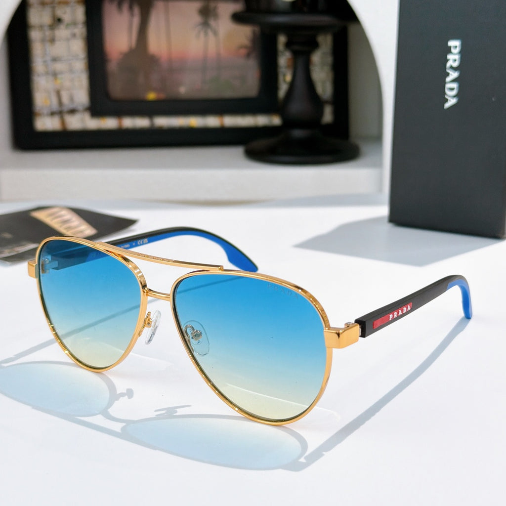 Prada sunglasses with gold frame and blue gradient lenses