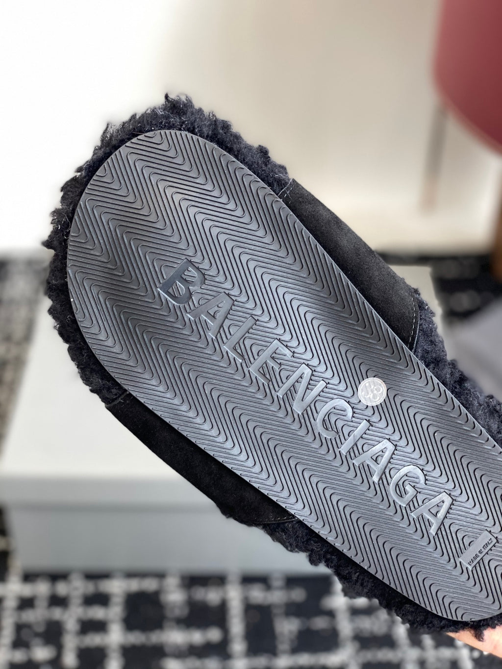 Black slide sandal outsole with patterned tread and logo text