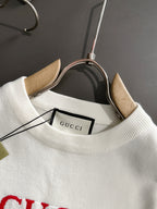 White crewneck sweatshirt with Gucci label at neckline, long sleeves