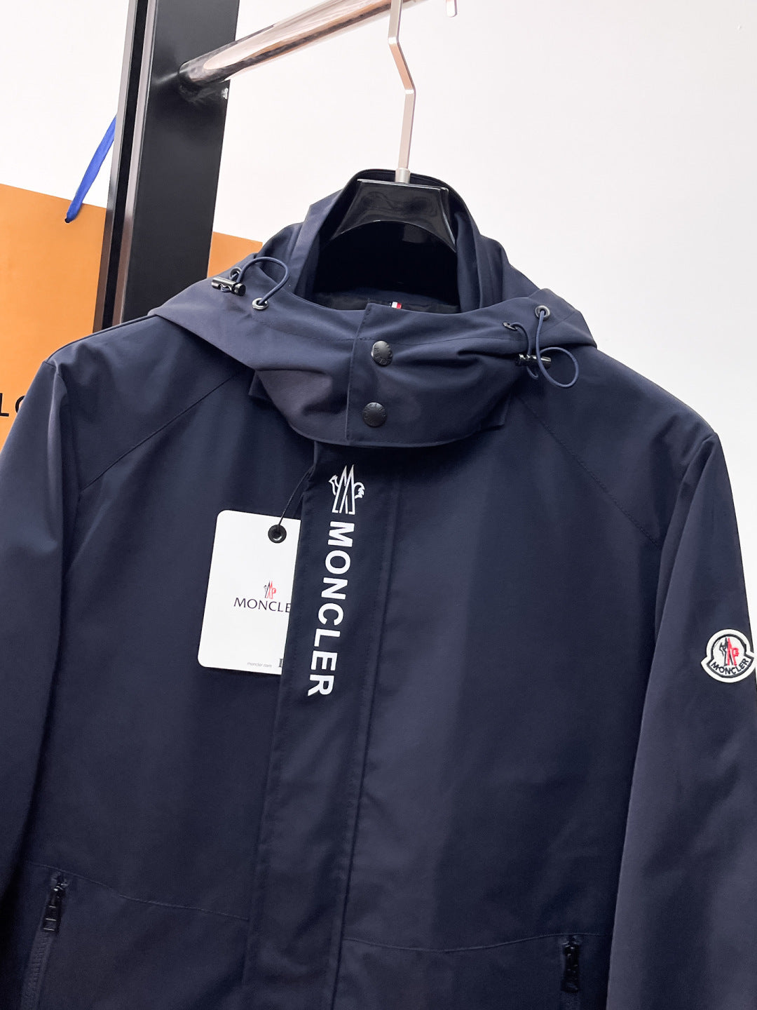 Navy Moncler long hooded jacket with chest logo and front zipper