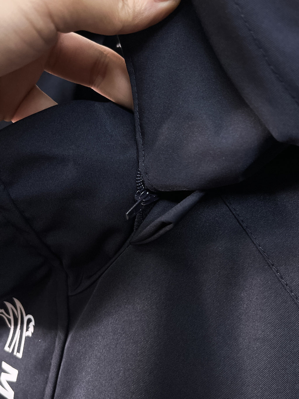 Navy Moncler jacket hem with adjustable drawstring and zipper seam