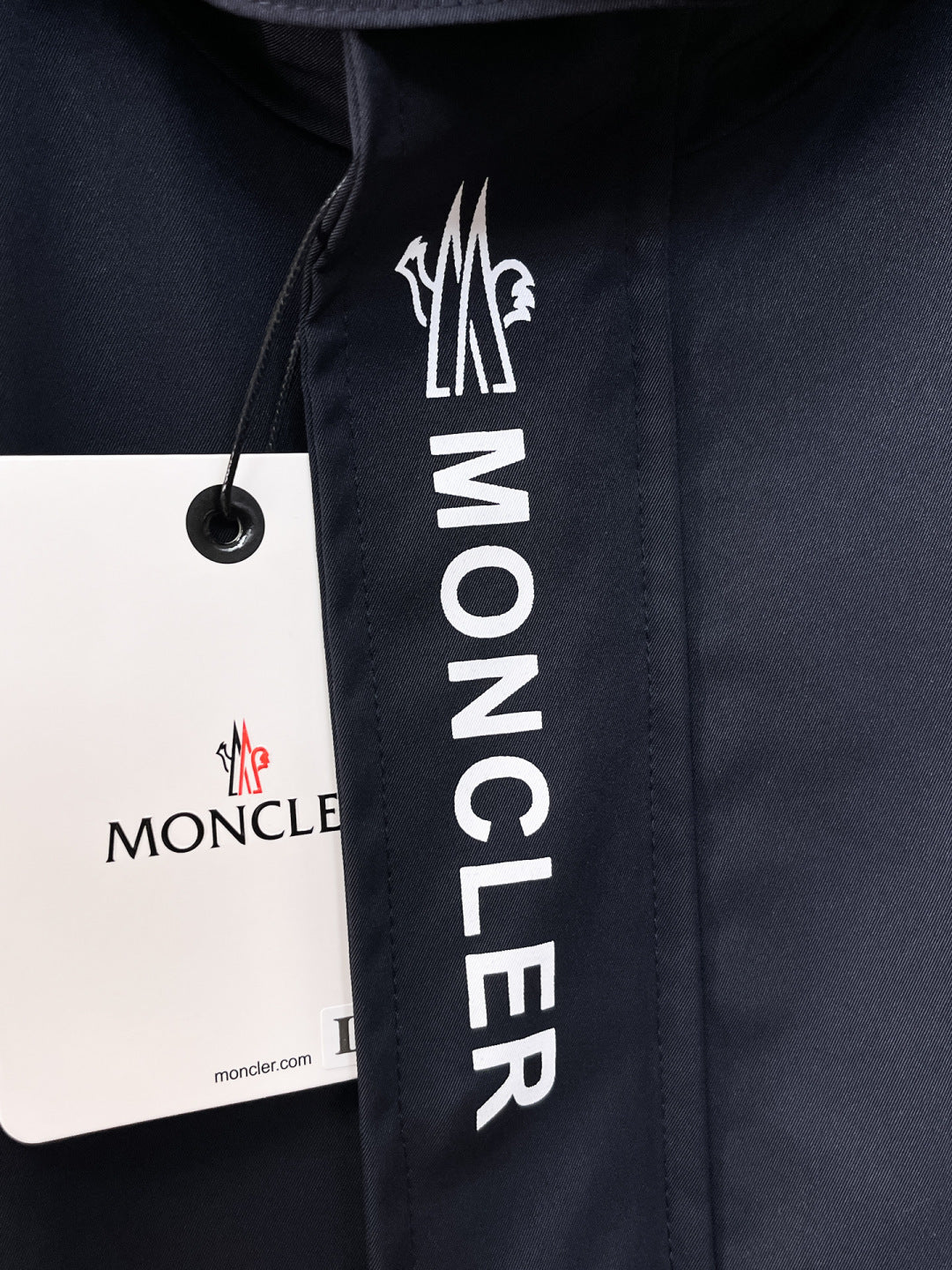 Moncler logo patch on navy hooded jacket front