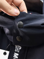 Navy Moncler jacket pocket flap with snap button and logo detail