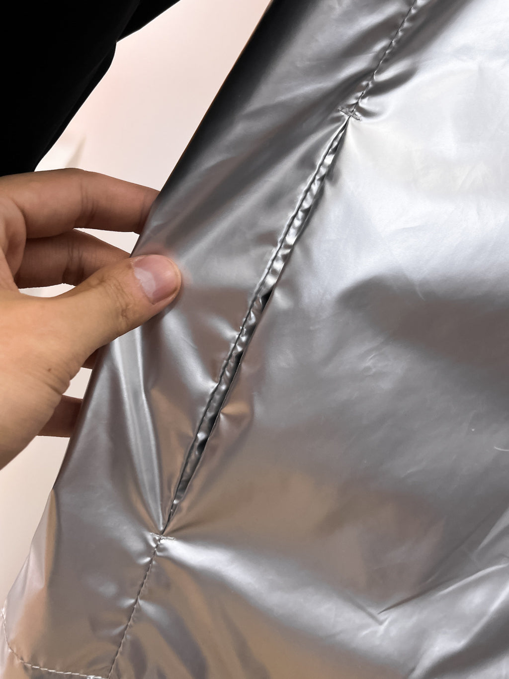 Moncler silver panel fabric seam close-up with stitched quilting