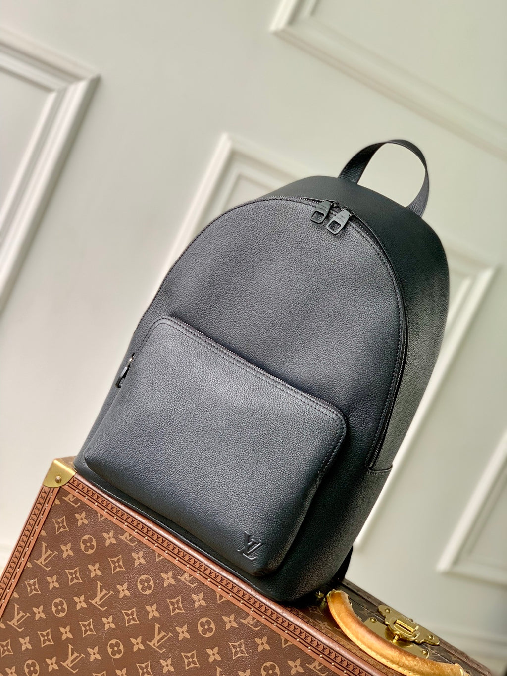 Men's Louis Vuitton leather backpack in dark gray with top handle and front zip pocket