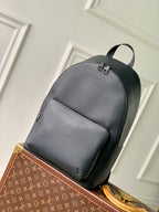Men's Louis Vuitton leather backpack in dark gray with top handle and front zip pocket