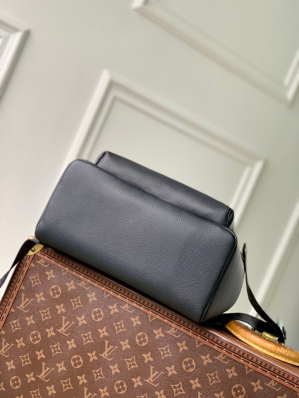 Men's Louis Vuitton leather backpack with top flap and adjustable shoulder strap