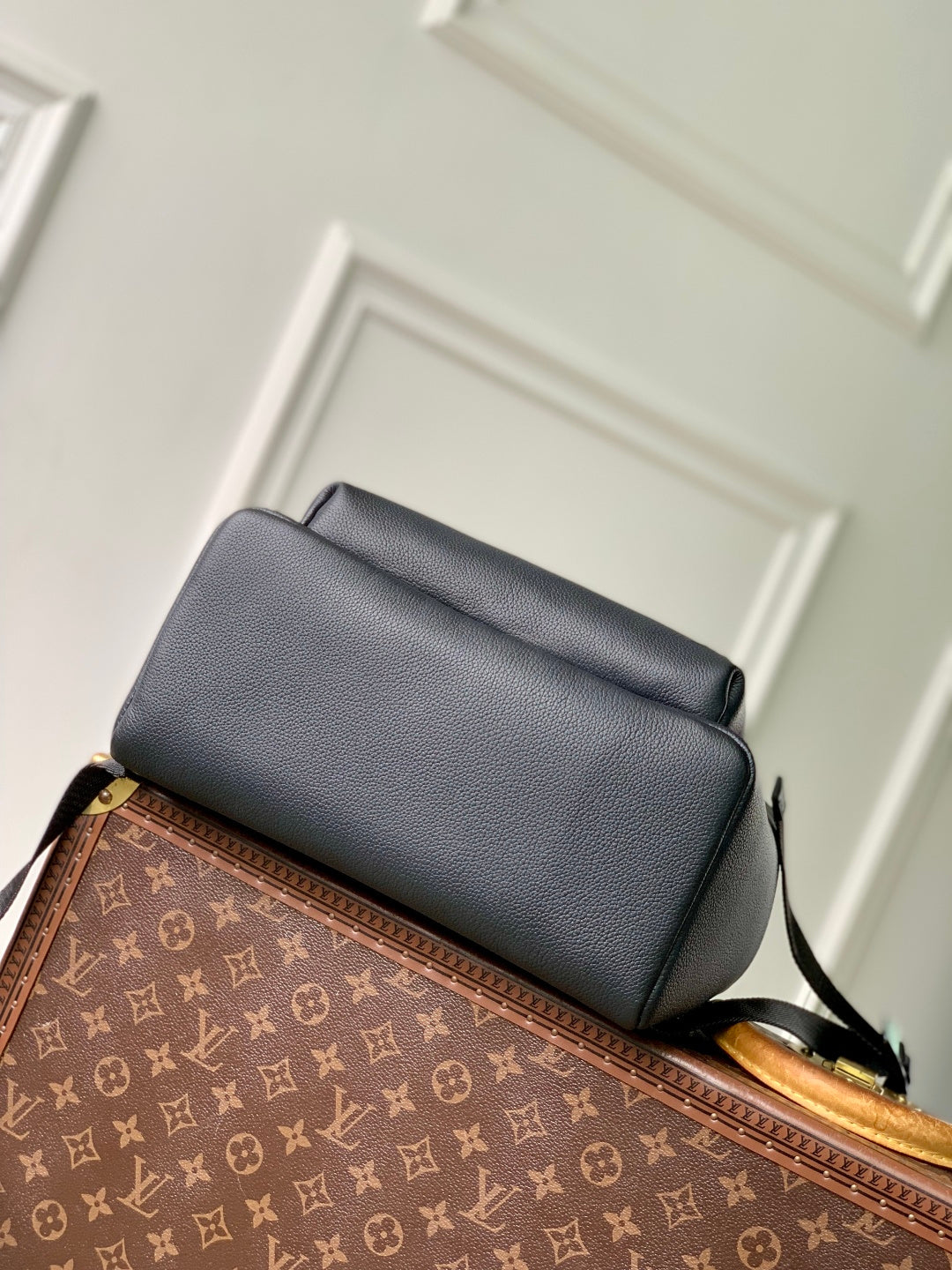 Men's Louis Vuitton leather backpack with top flap and adjustable shoulder strap
