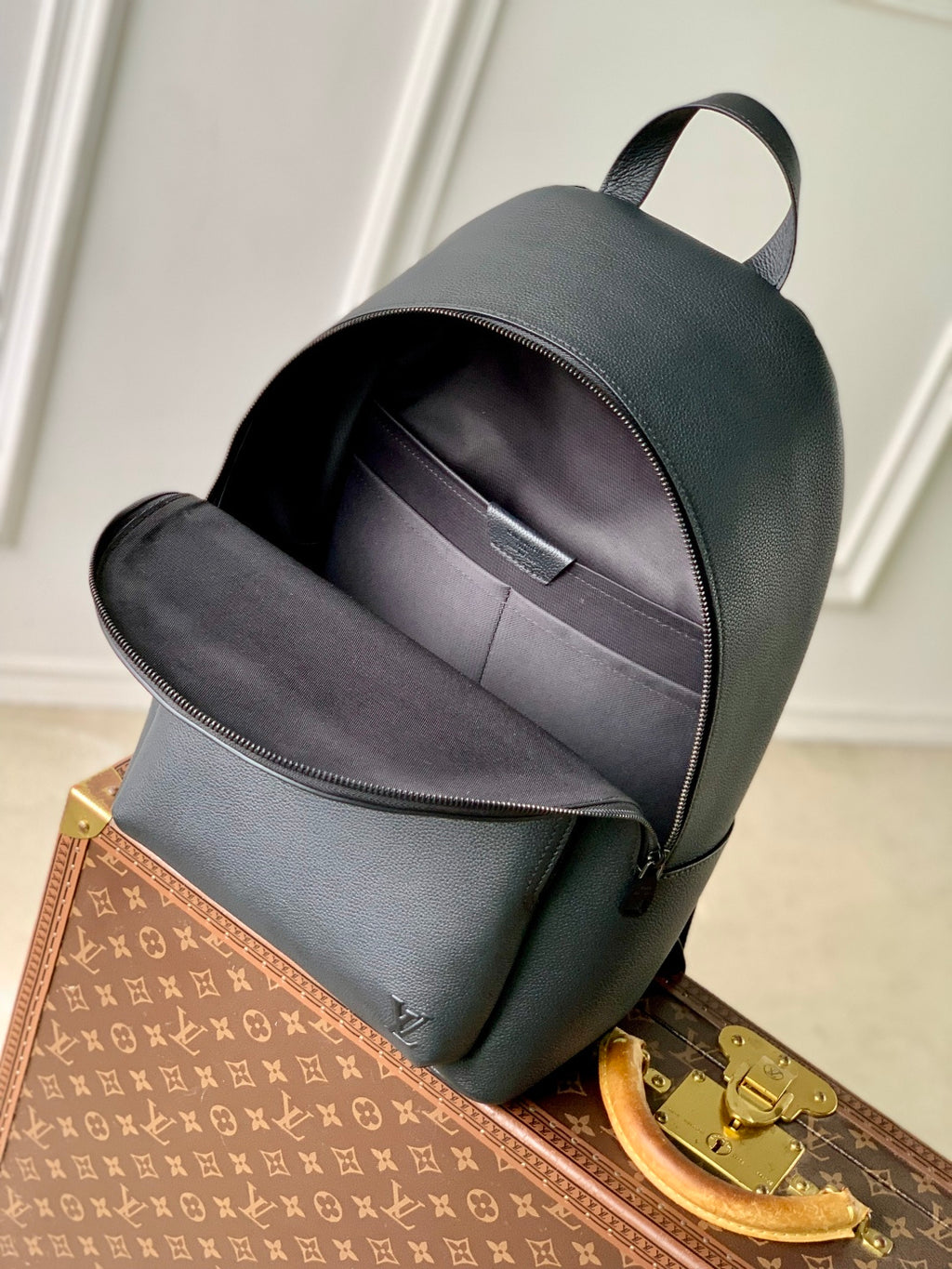 Men's Louis Vuitton leather backpack front view with main zipper and front compartment