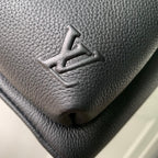 Men's Louis Vuitton leather backpack close-up of embossed logo on textured surface