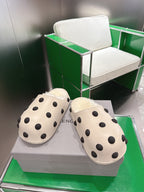 Balenciaga white polka-dot slide sandals, angled view of the pair
