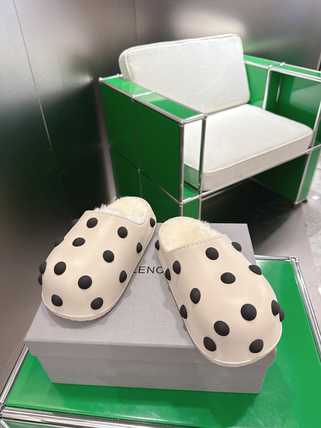 Balenciaga white polka-dot slide sandals, angled view of the pair