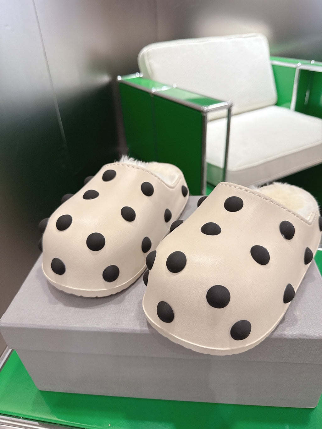 Balenciaga white polka-dot slide sandals, pair resting on the box