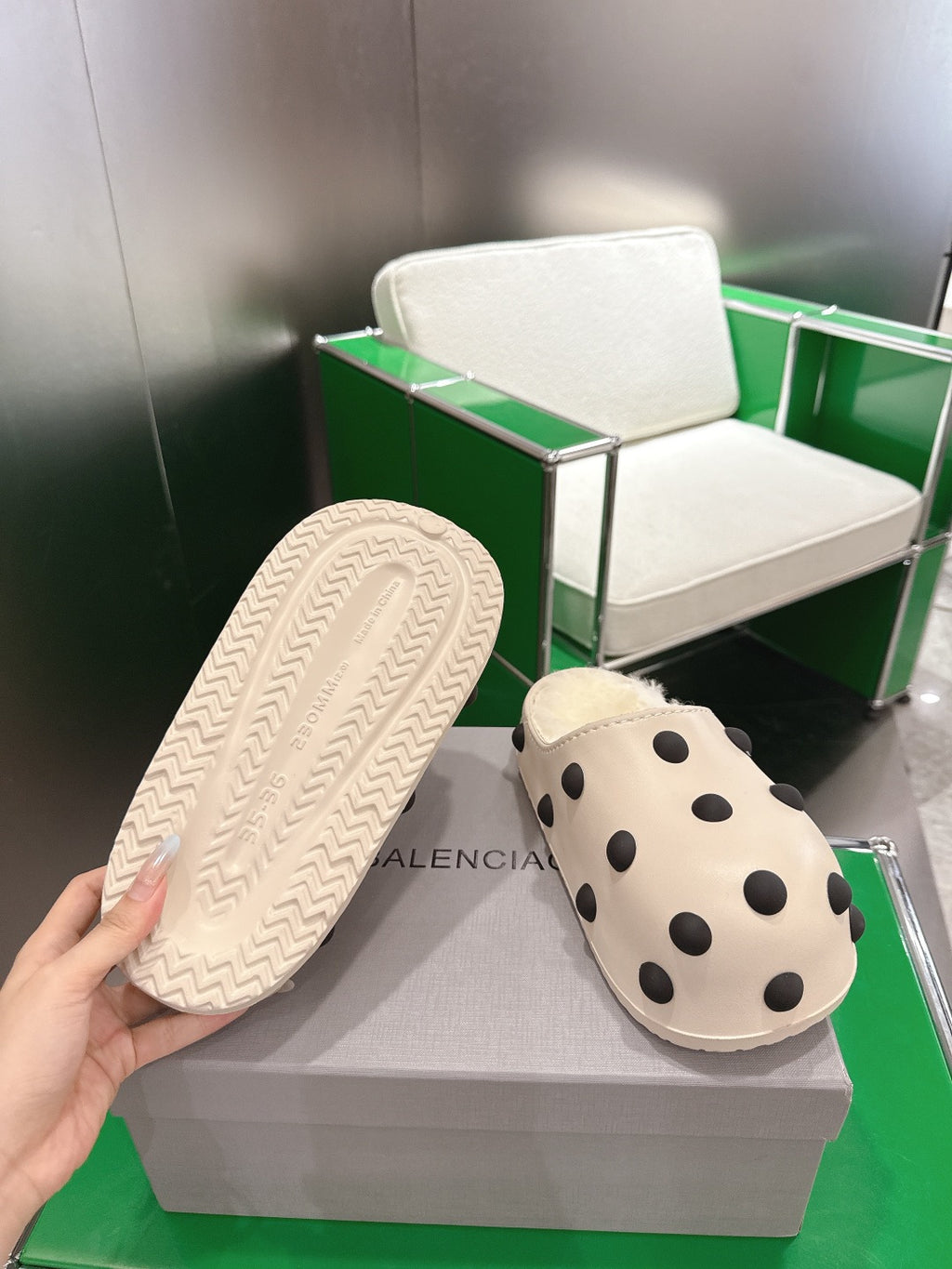 Balenciaga white polka-dot slide sandal, view of textured rubber outsole