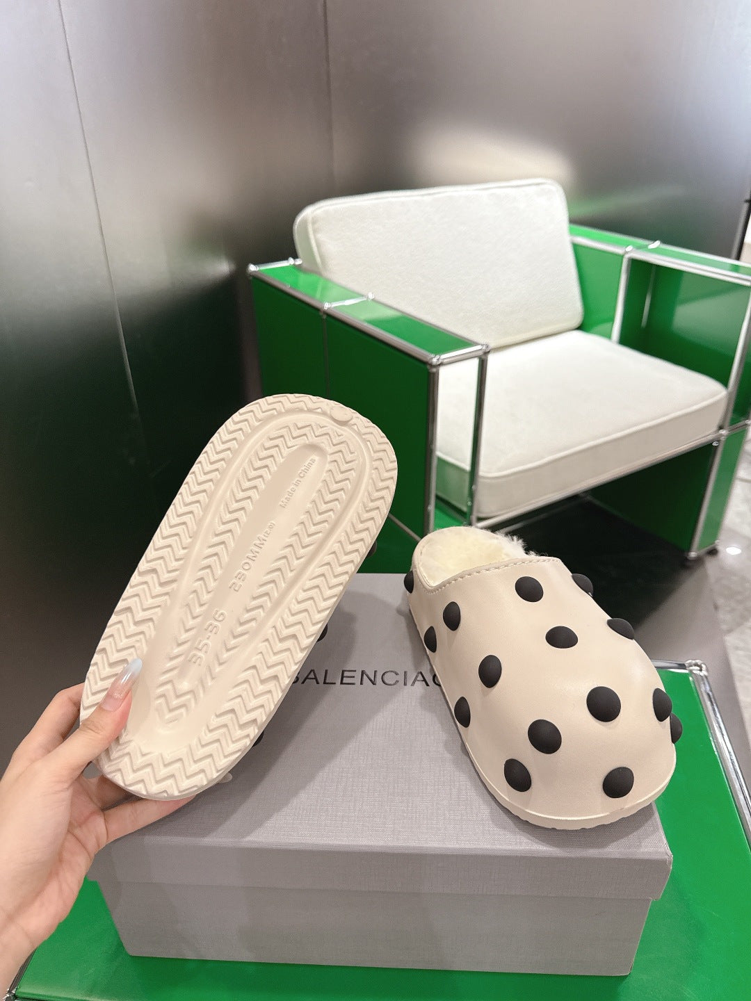 Balenciaga white polka-dot slide sandal, view of textured rubber outsole