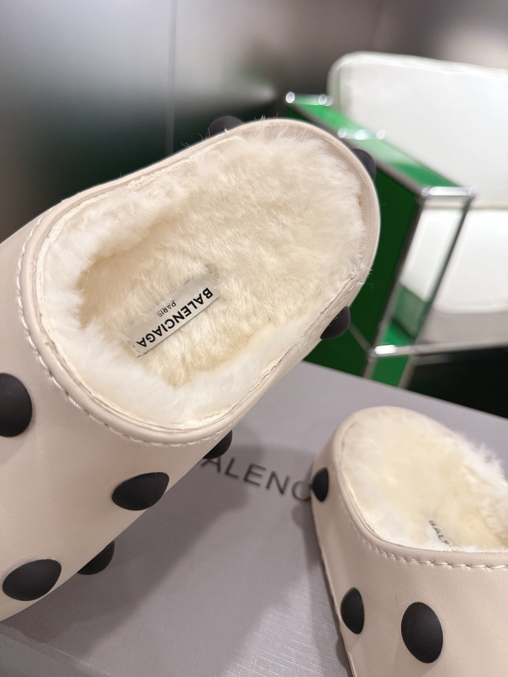 Balenciaga white polka-dot slide sandals, close-up of plush insole and logo