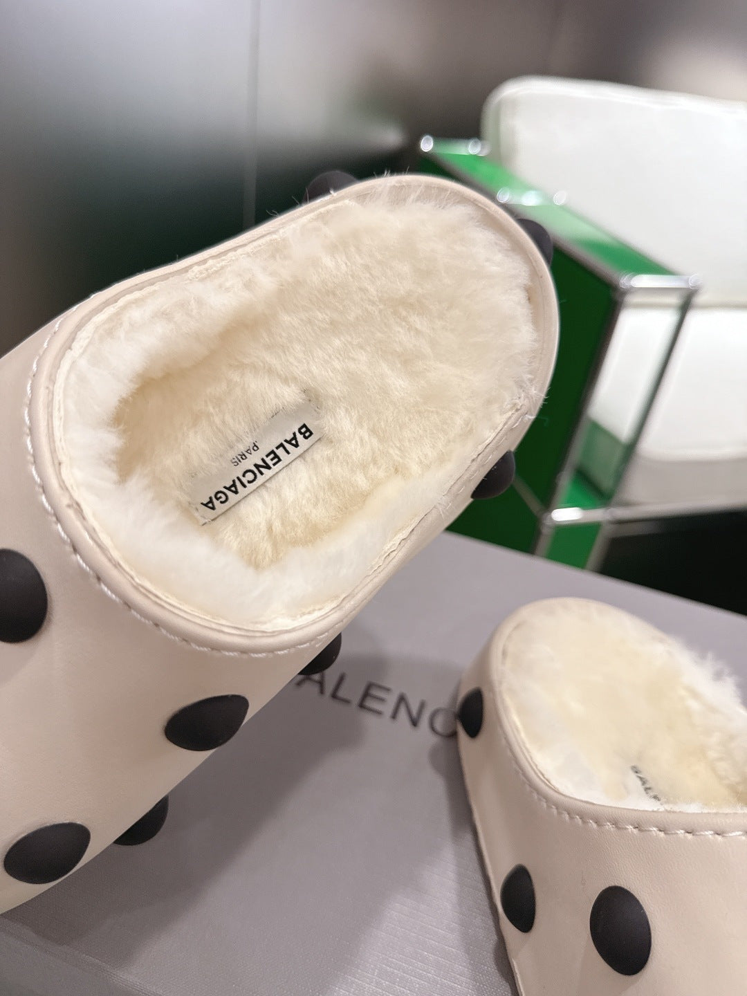 Balenciaga white polka-dot slide sandals, close-up of plush insole and logo